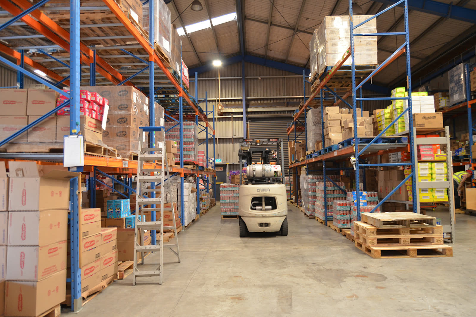An orderly International Foods Limited warehouse aisle